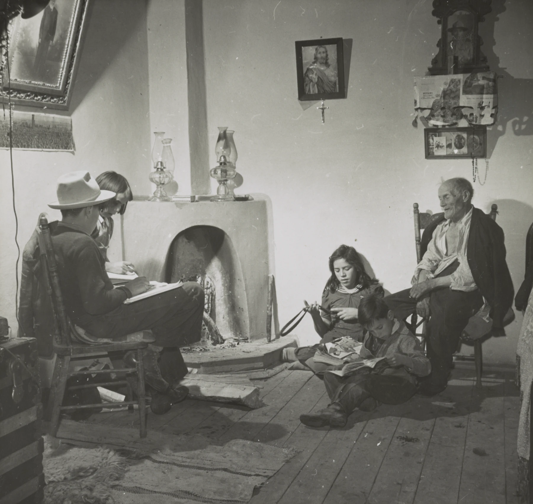 The Lopez children listening to their grandfather in Trampas, New Mexico, photographed by John Collier in 1943